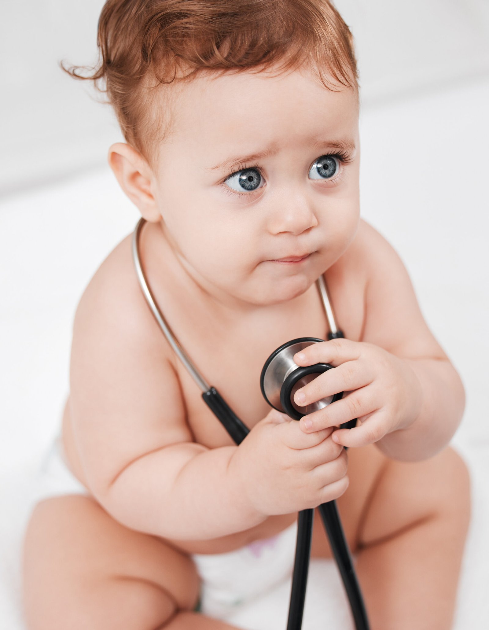 about us Shot of an adorable little baby boy hold a stethoscope in a clinic during his checkup.